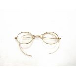 A pair of vintage yellow metal framed spectacles