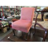 A pink fabric nursing chair