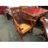 A brass inlaid rocking chair with rattan seat,