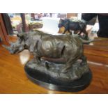 A large bronze Rhino figure on a shaped marble base,