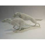 A Kaiser poreclain matt white figure of hounds running, model no.