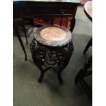 A carved Chinese jardiniere stand with rouge marble insert,