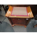 An Art Deco walnut piano box stool with pull-down three division sheet music interior over squat