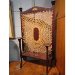 An Art Nouveau mahoganany fire screen with cane work panel