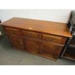 A Multiyork 17th Century style oak dresser base of three drawers over fielded panel three door