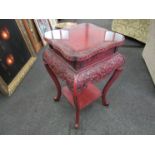 A Chinese red cinnabar occasional table carved and lacquered with glass protector,
