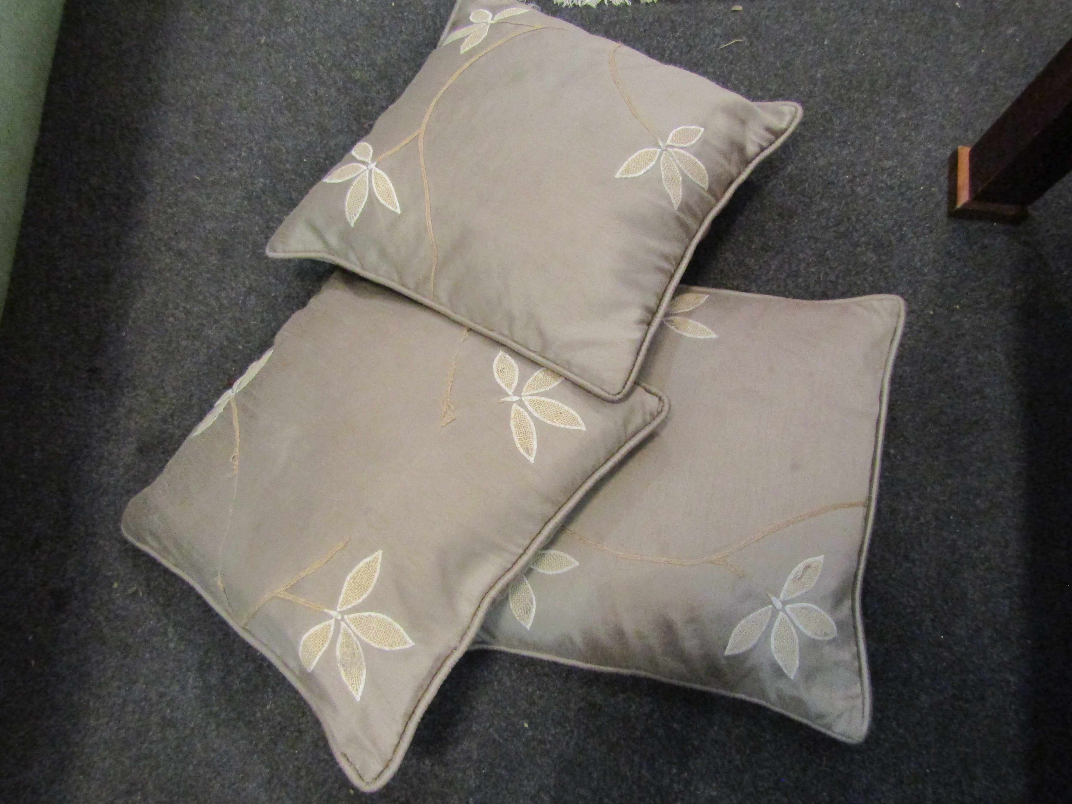 Three silk cushions with leaf detail