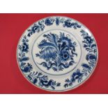 A Dutch Delft plate painted in blue and white with flowers, 18th Century,