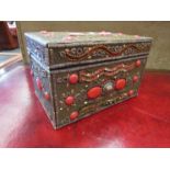 An ornate jewellery box with bijouterie contents