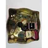 A tin of costume jewellery including cameo brooch, silver ring etc.