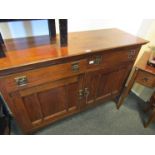 An early 20th Century oak Arts and Crafts sideboard with two drawer two cupboard door base,