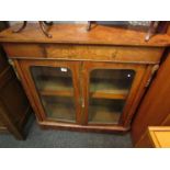 A 19th Century maple pier cabinet with gilt embellishment,