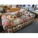 A three seater large sofa with Aztec design upholstery