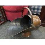 A copper helmet form coal scuttle