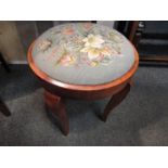 A walnut circular stool with floral needlepoint seat on cabriole legs,