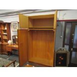 A mid Century Uniflex teak wardrobe, two pairs of doors,