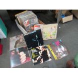 A box of assorted LPs and 7" singles including The Beatles, Bob Dylan,