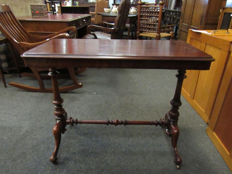 A Victorian mahogany stretcher table with brass castors and turned supports, - Image 3 of 4
