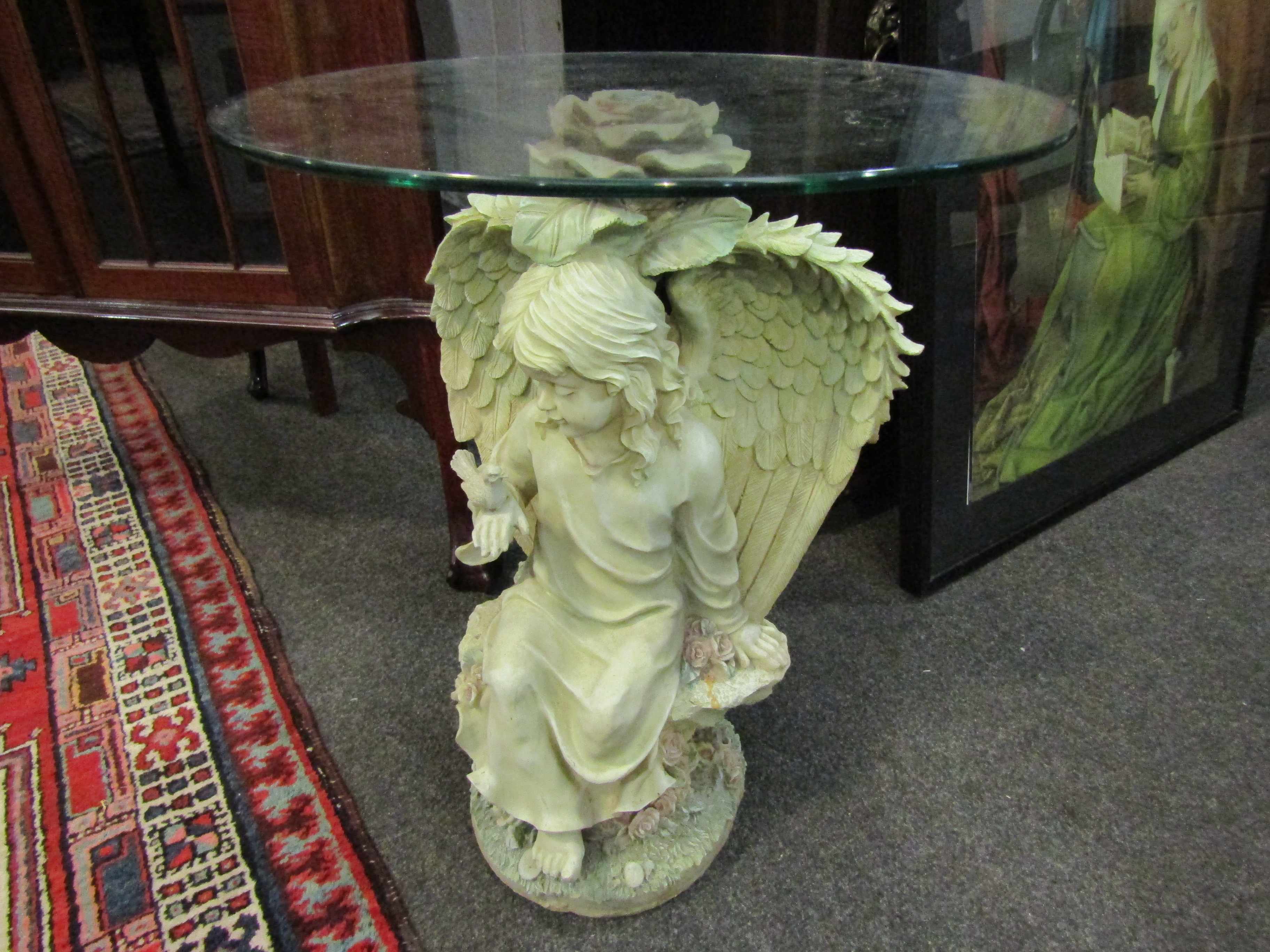 A modern glass topped occasional table with Angel design base, 57. - Image 2 of 7