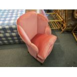 A circa 1940 pink upholstered cloud back bedroom chair the serpentine front seat on turned legs,