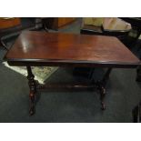 A Victorian mahogany stretcher table with brass castors and turned supports,