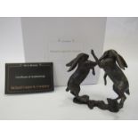 A pair of limited edition solid bronze boxing hares, boxed with certificate, 9cm tall.