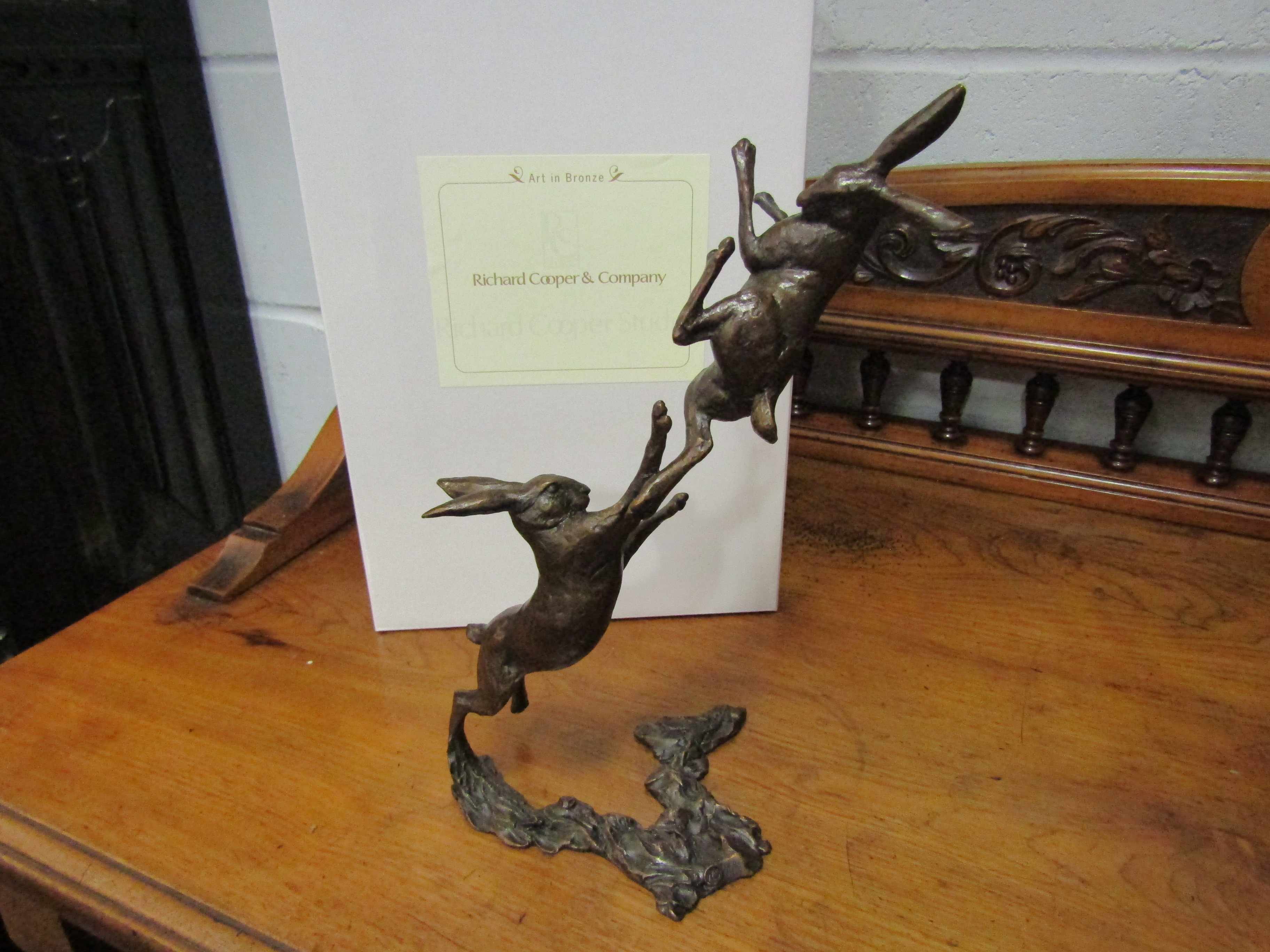 A pair of limited edition solid bronze boxing hares, boxed with certificate, 122/250,