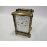A late 19th Century brass French brass carriage timepiece with enamelled Roman dial, 8 day movement,