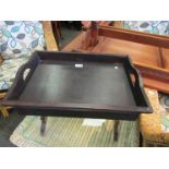 A wooden tray with drawer and wooden framed stool