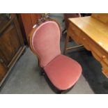 An early Victorian walnut bedroom chair the spoon backrest with carved crest over scroll front