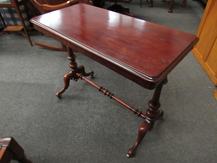 A Victorian mahogany stretcher table with brass castors and turned supports, - Image 2 of 4