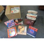 A box and a case of 7" singles including Dave and Ansil Collins, Traffic, Sparks, Sylvester, T-Rex,