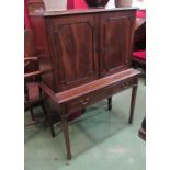 An early 19th Century mahogany estate cabinet with two doors and key having six interior drawers