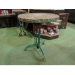 A 19th Century green painted cast iron tripod table with stone top