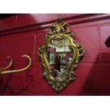 A Rococo style gilt and gesso mirror,