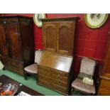 A George III oak two door cupboard on bureau of four drawers with key, 187cm tall,