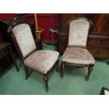 A pair of French Victorian carved walnut and ebonised chairs with turned and chamfered legs on