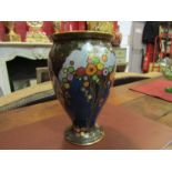 A Crown Devon lustre vase decorated with blossoming trees, hairlines to top, small chip to foot,