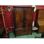 A George III flame mahogany two door wardrobe with inlaid daisy and reeded decoration over three