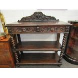 A circa 1880 carved oak 'Greenman' three tier serving table the raised back over two frieze drawers