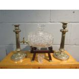 A pair of plated candlesticks and a crystal barrel form decanter on stand,