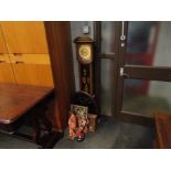 Various Oriental tourist dolls, lacquered oval panel, quartz grandmother clock,