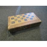 A folding chess/draughts board as faux books,