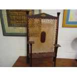 An Art Nouveau mahogany fire screen with cane work panel,