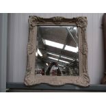 A bevelled glass mirror,