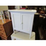 A white painted two door cupboard