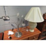 A ceramic table lamp with leaf design and cream pleated shade,