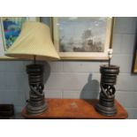 A pair of hardwood table lamps, one with shade,