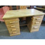 A mid 20th Century seven drawer twin pedestal desk, 123cm wide, 76cm tall,