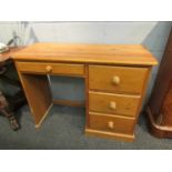 A modern pine four drawer desk